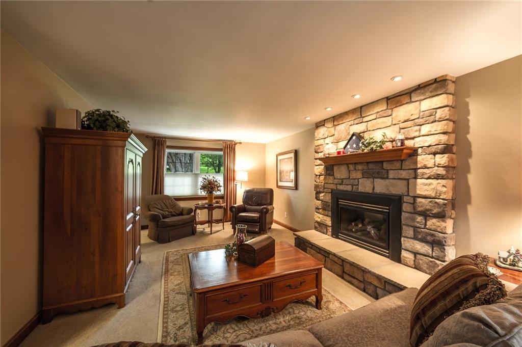 2387 Harrison City Road Export, PA 15632 - Photo 4 of 25 a living room with furniture a flat screen tv and a fireplace