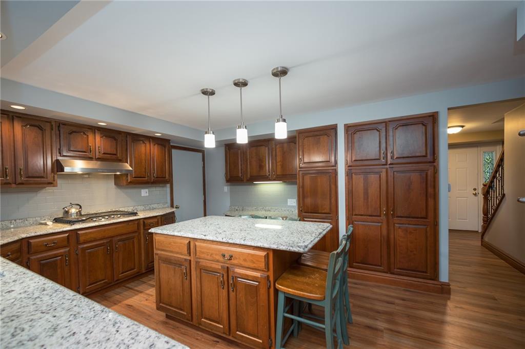 2387 Harrison City Road Export, PA 15632 - Photo 6 of 25 a kitchen with stainless steel appliances kitchen island granite countertop a sink refrigerator and cabinets