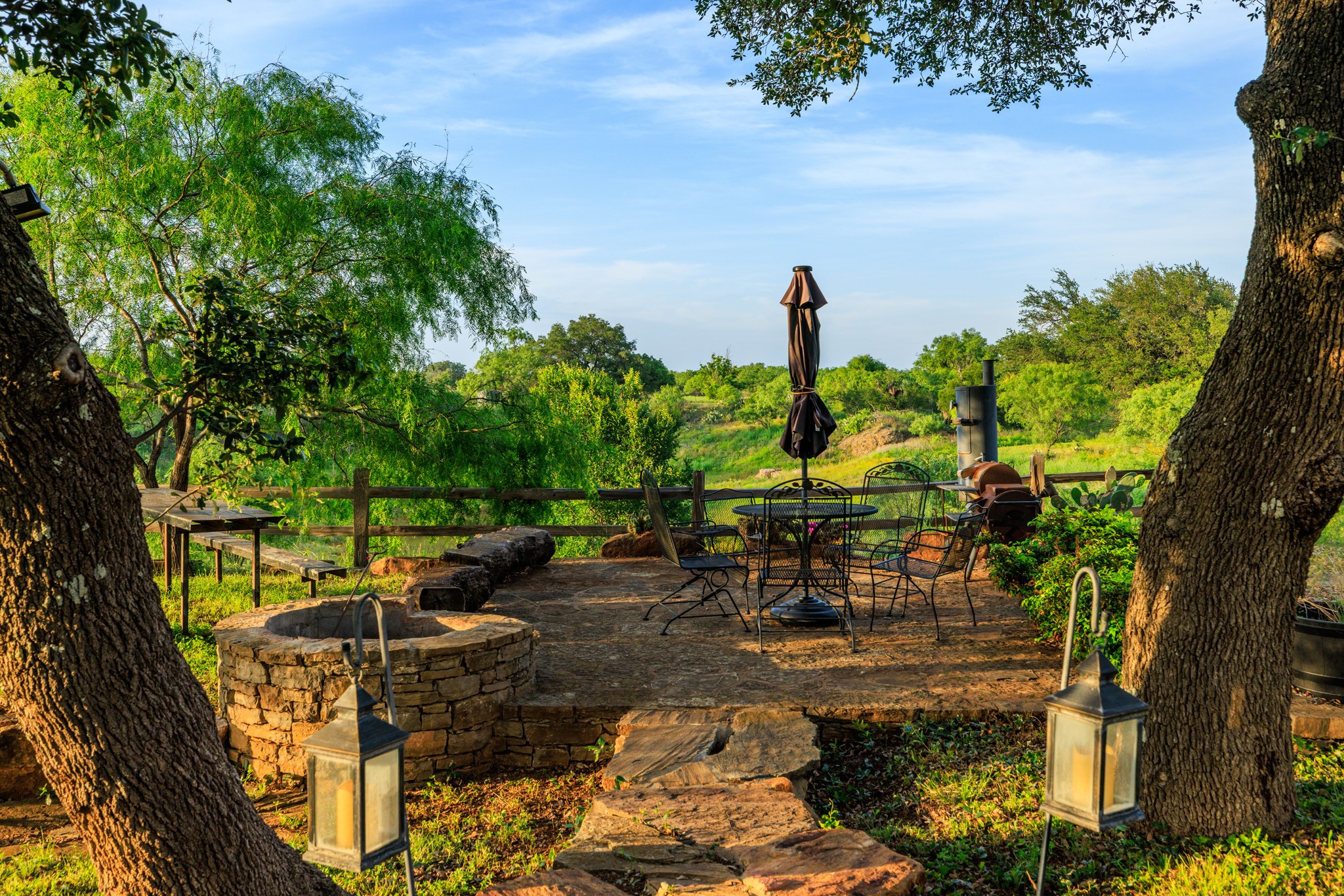 3724 Ranch Road 3347 Round Mountain, TX 78663 - Photo 23 of 40 a backyard of a house with table and chairs