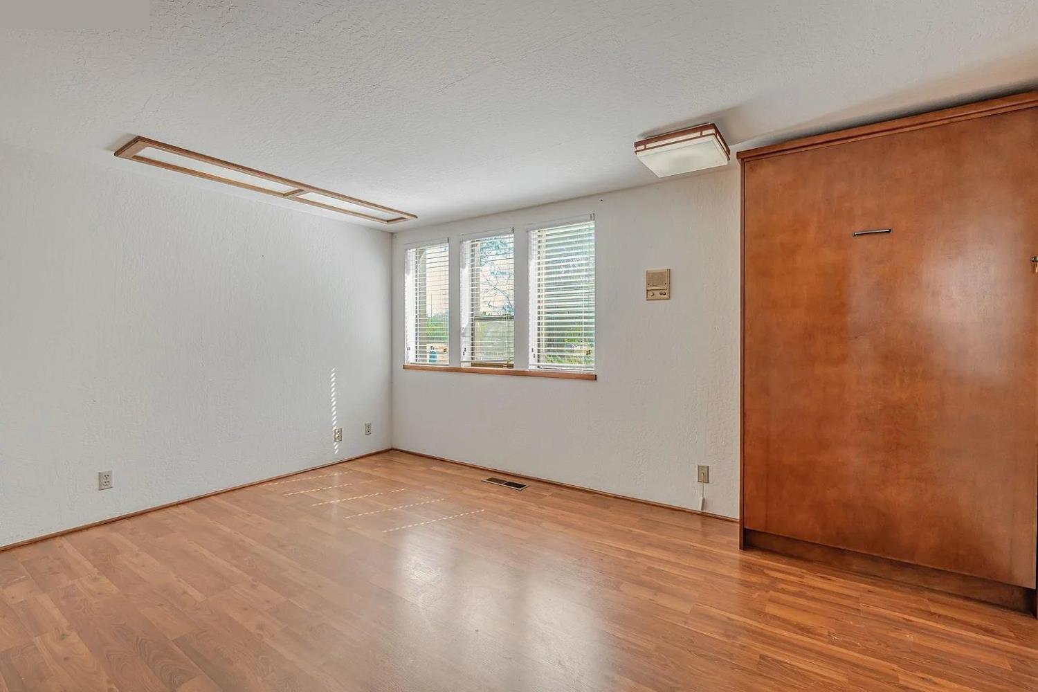 4607 Archerdale Road Linden, CA 95236 - Photo 23 of 50 a view of an empty room with wooden floor and a window