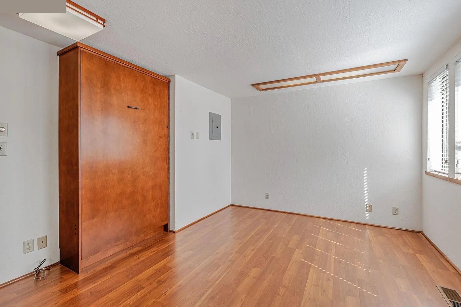 4607 Archerdale Road Linden, CA 95236 - Photo 24 of 50 an empty room with wooden floor closet and windows