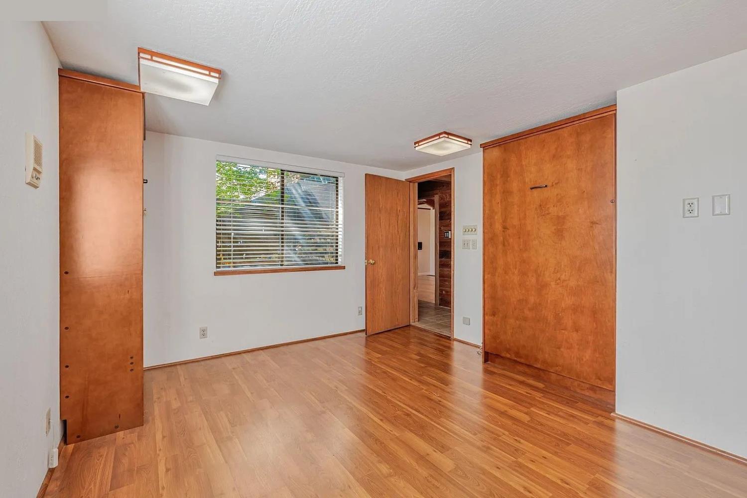 4607 Archerdale Road Linden, CA 95236 - Photo 25 of 50 an empty room with wooden floor and windows