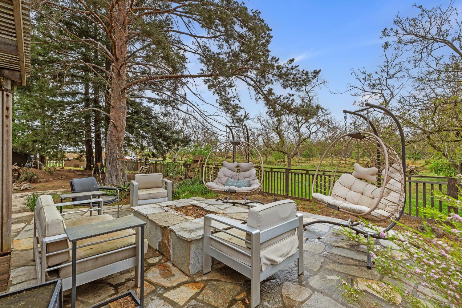 4607 Archerdale Road Linden, CA 95236 - Photo 29 of 50 a view of a patio with couches and table and chairs with wooden floor and fence