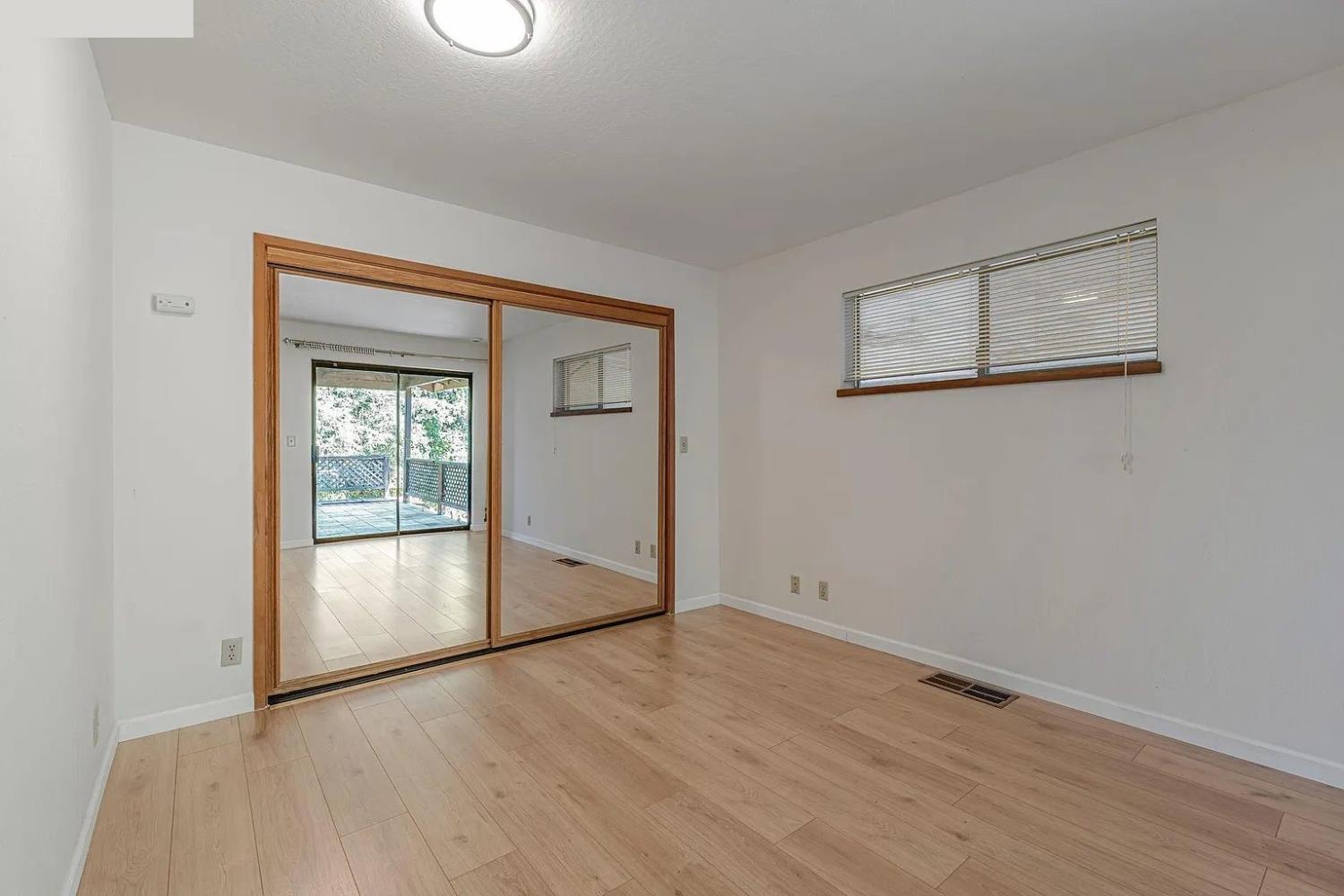 4607 Archerdale Road Linden, CA 95236 - Photo 43 of 50 an empty room with wooden floor and windows