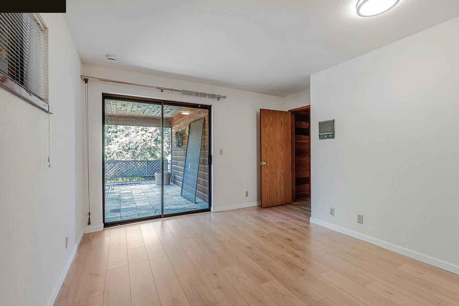 4607 Archerdale Road Linden, CA 95236 - Photo 45 of 50 an empty room with wooden floor and windows