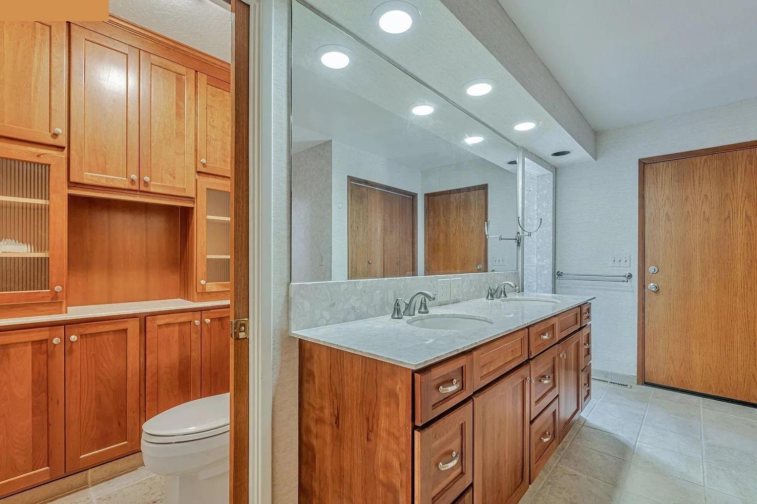 4607 Archerdale Road Linden, CA 95236 - Photo 49 of 50 a bathroom with a granite countertop sink and a mirror