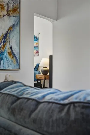 a bedroom with a bed and a painting on the wall