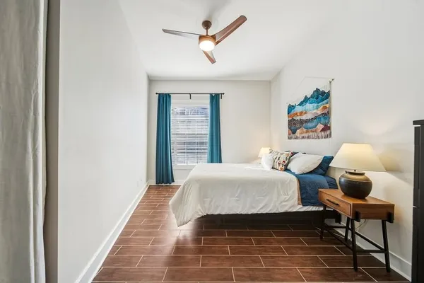 a bedroom with a bed and a chandelier