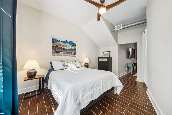 a bedroom with a bed and a lamp on table