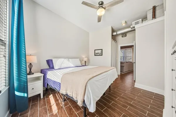 a bedroom with a bed and a chandelier