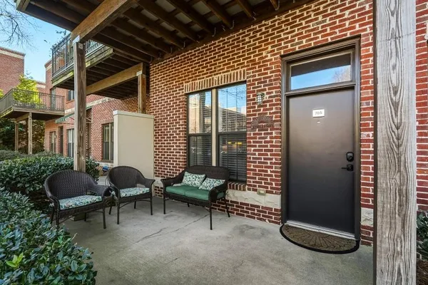 a backyard of a house with outdoor seating