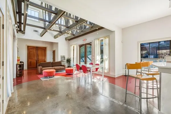 a living room filled with lots of furniture and a chandelier