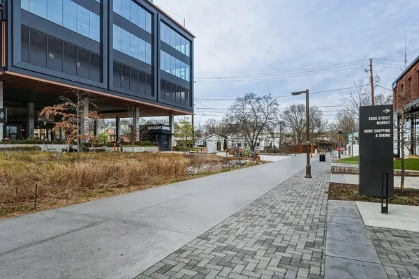 a view of building with yard outdoor seating and barbeque oven
