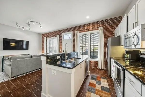 a kitchen that has a sink and a stove top oven