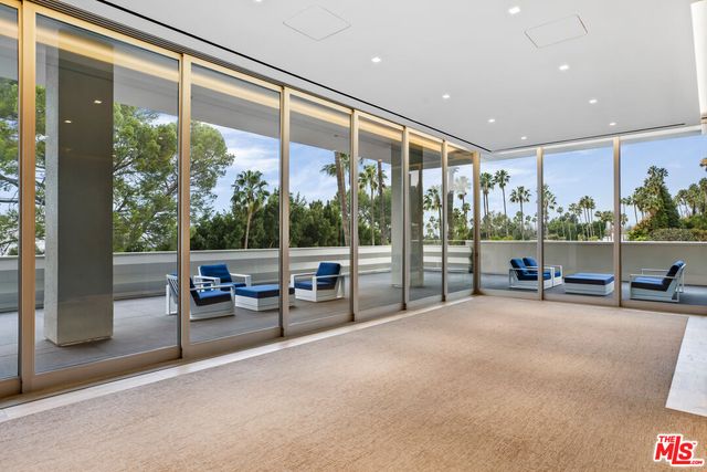 a view of a porch with chairs and backyard