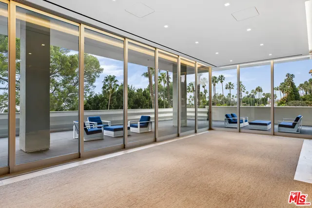a view of a porch with chairs and backyard