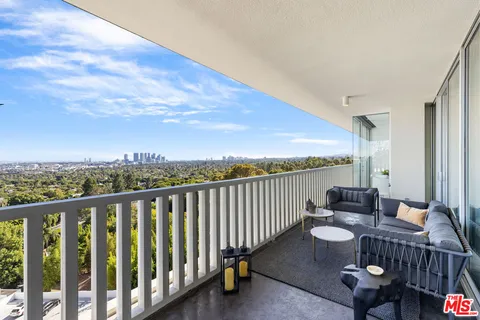 a view of a balcony with chair and wooden floor