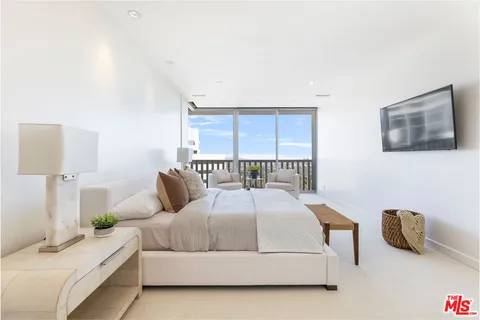 a bedroom with a bed a couch and a table