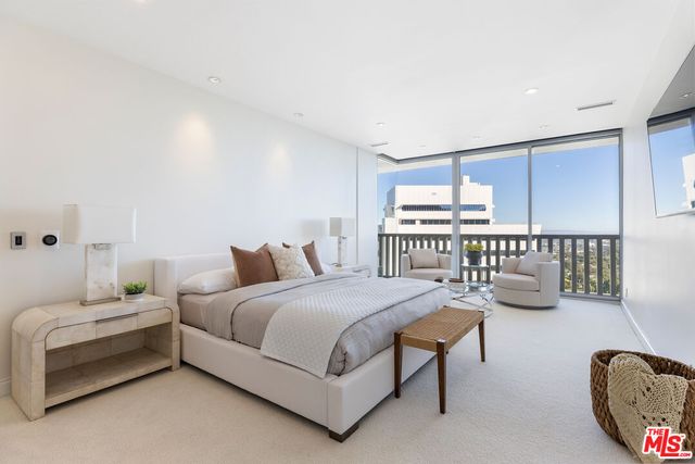 a bedroom with a bed couch and window