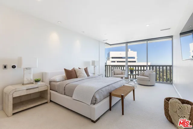 a bedroom with a bed couch and window