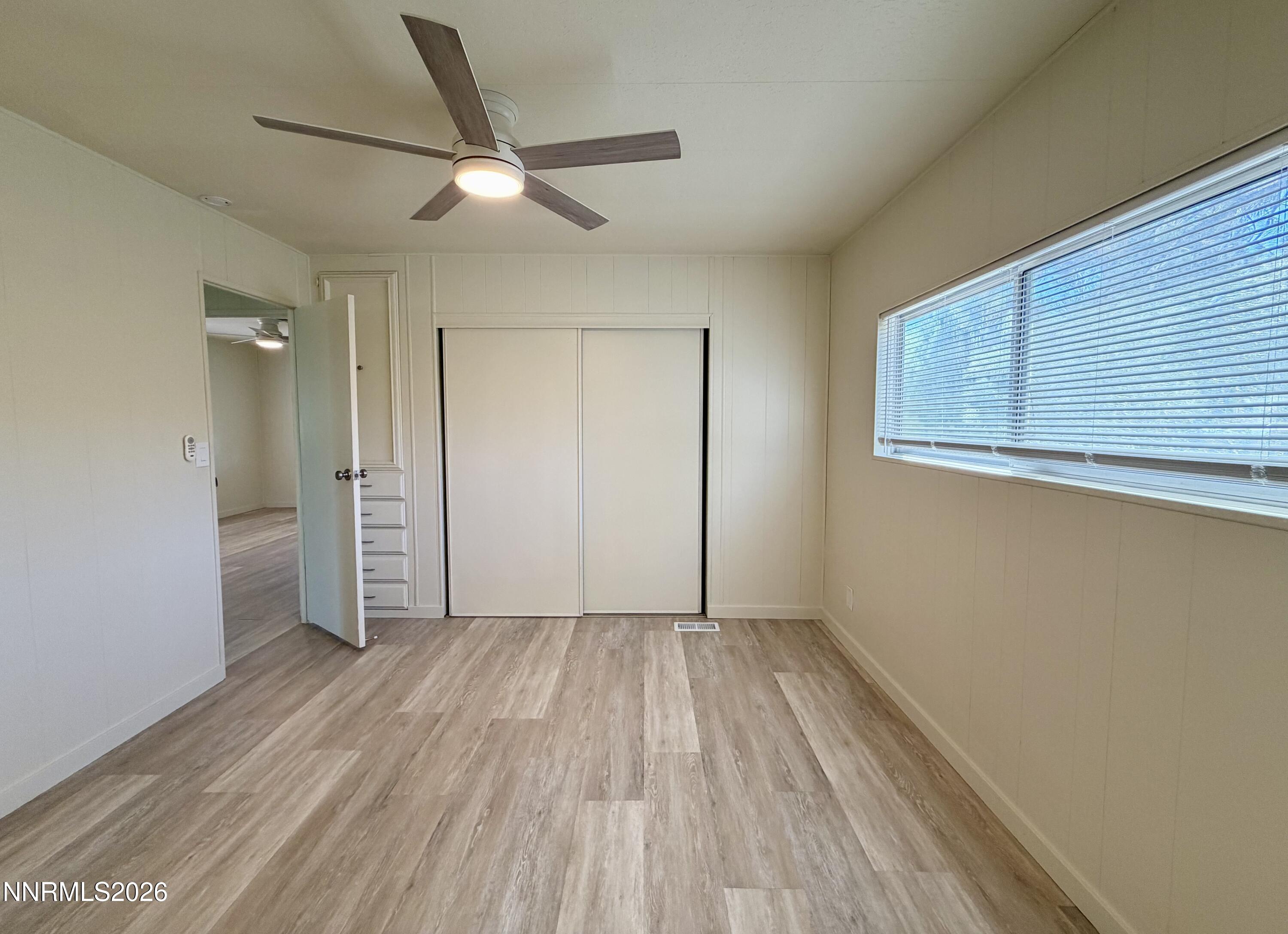 330 Taurus Circle Reno, NV 89521 - Photo 16 of 27 a view of an empty room with wooden floor and a window