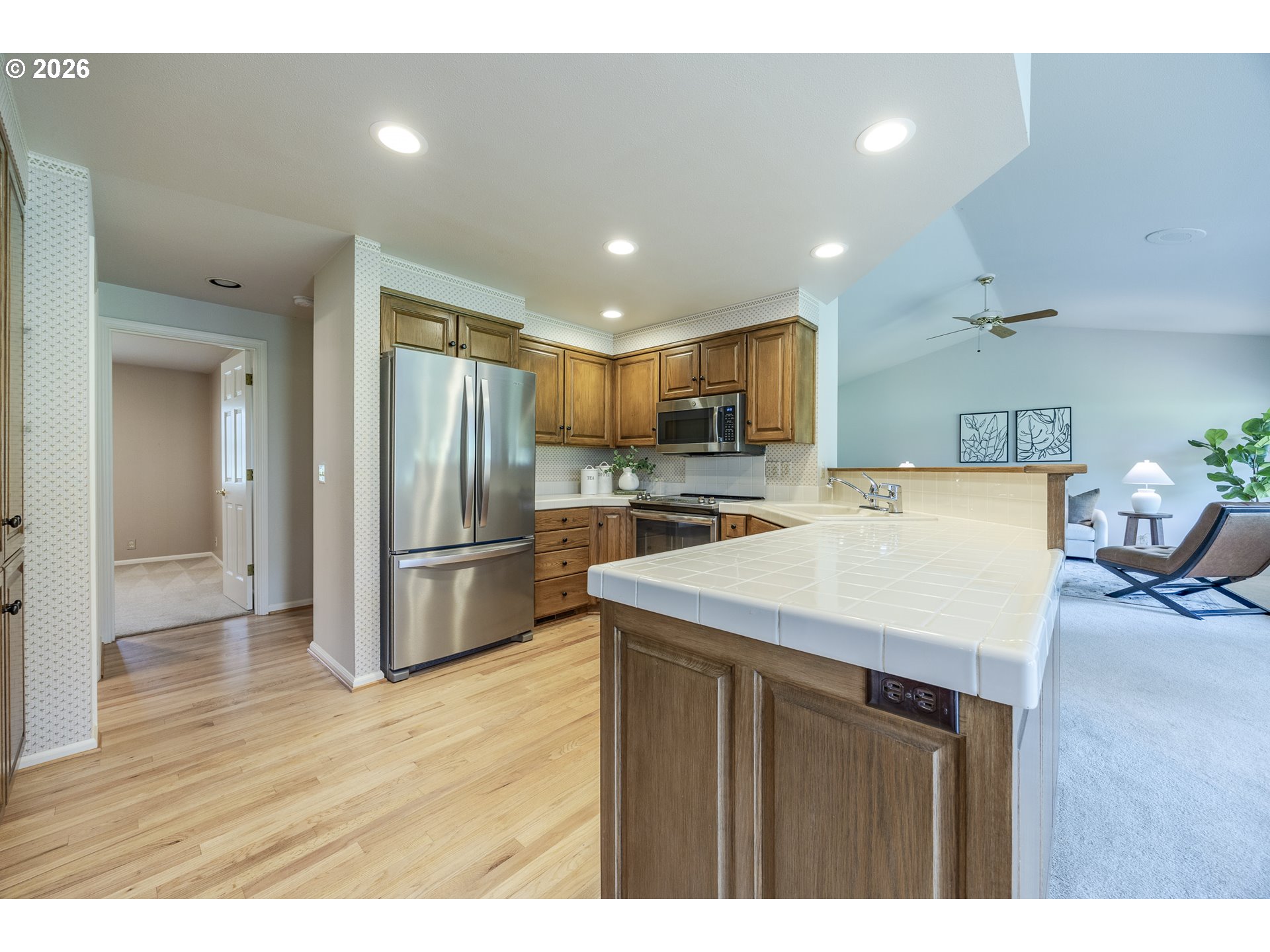 982 Shaughnessy Lane Eugene, OR 97401 - Photo 18 of 48 a kitchen with a refrigerator a sink dishwasher with a oven and wooden cabinets