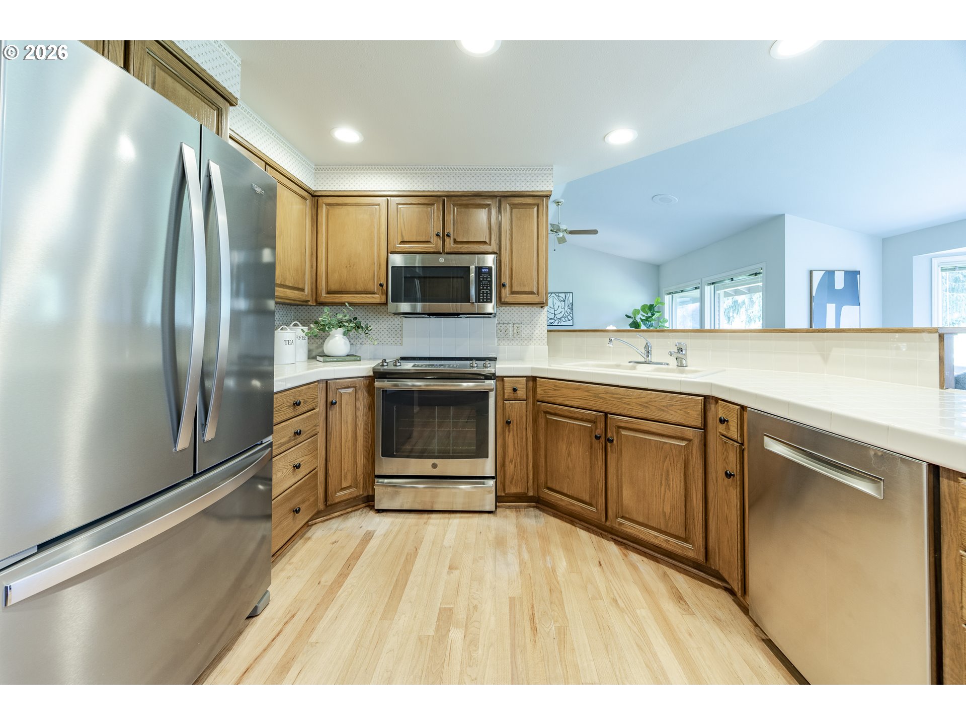 982 Shaughnessy Lane Eugene, OR 97401 - Photo 20 of 48 a kitchen with stainless steel appliances granite countertop a refrigerator a sink dishwasher a stove with wooden cabinets