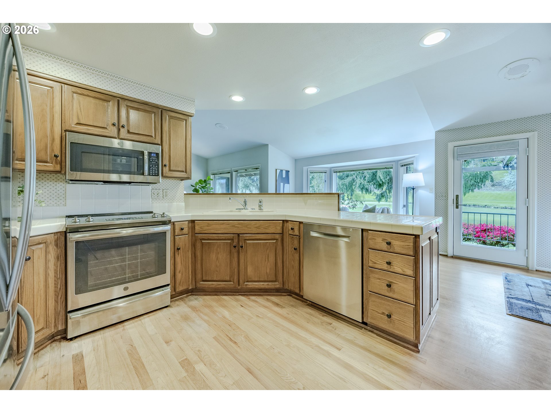 982 Shaughnessy Lane Eugene, OR 97401 - Photo 21 of 48 a kitchen with stainless steel appliances a stove microwave and cabinets