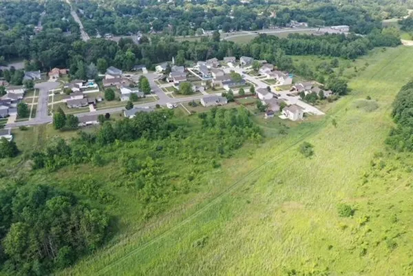 a view of a city with lush green forest