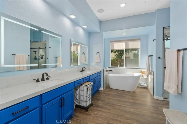 a bathroom with a large tub sink and mirror