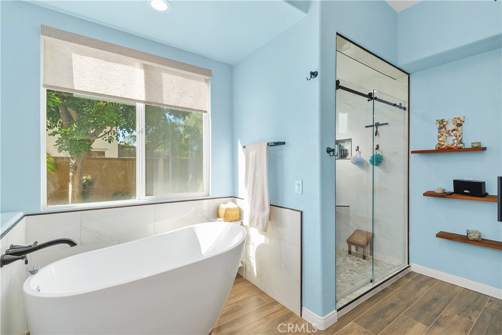 1195 Pamplona Drive Riverside, CA 92508 - Photo 19 of 39 The oversized shower features rolling doors, and built in shelving. Notice the tile backsplash surrounding the tub too!