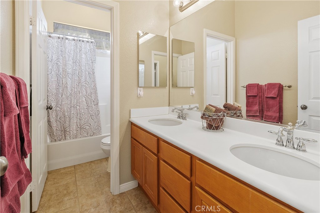 1195 Pamplona Drive Riverside, CA 92508 - Photo 25 of 39 The hall full bath features double sinks and a shower/tub