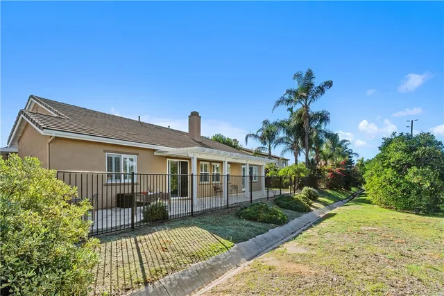 a view of house with backyard and garden