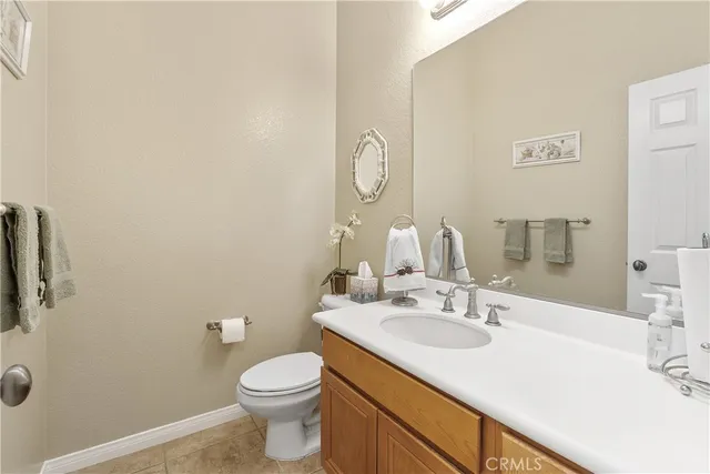 a bathroom with a sink vanity mirror and toilet