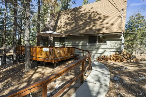 a view of a house with backyard and sitting area
