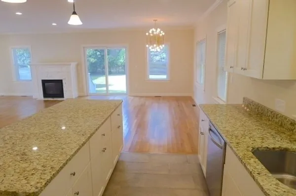 a view of kitchen and hall with wooden floor