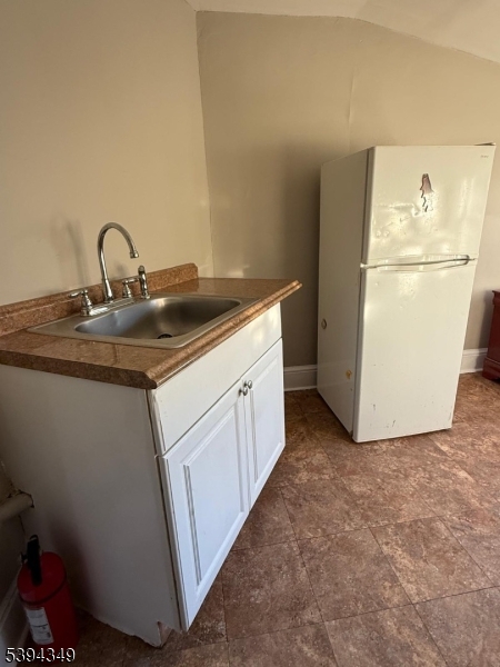 338 Union Avenue Irvington, NJ 07111 - Photo 6 of 8 a kitchen with a sink and a refrigerator