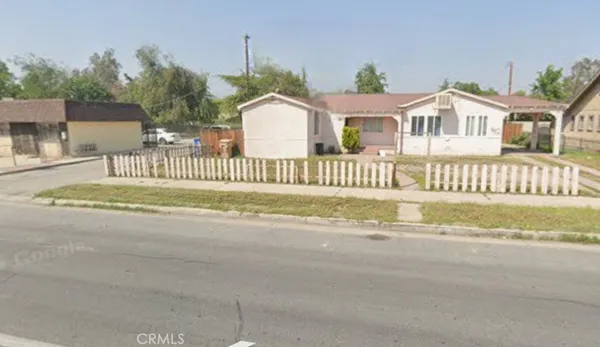 a front view of a house with a garden and deck