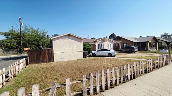 a front view of a house with a wrought fence