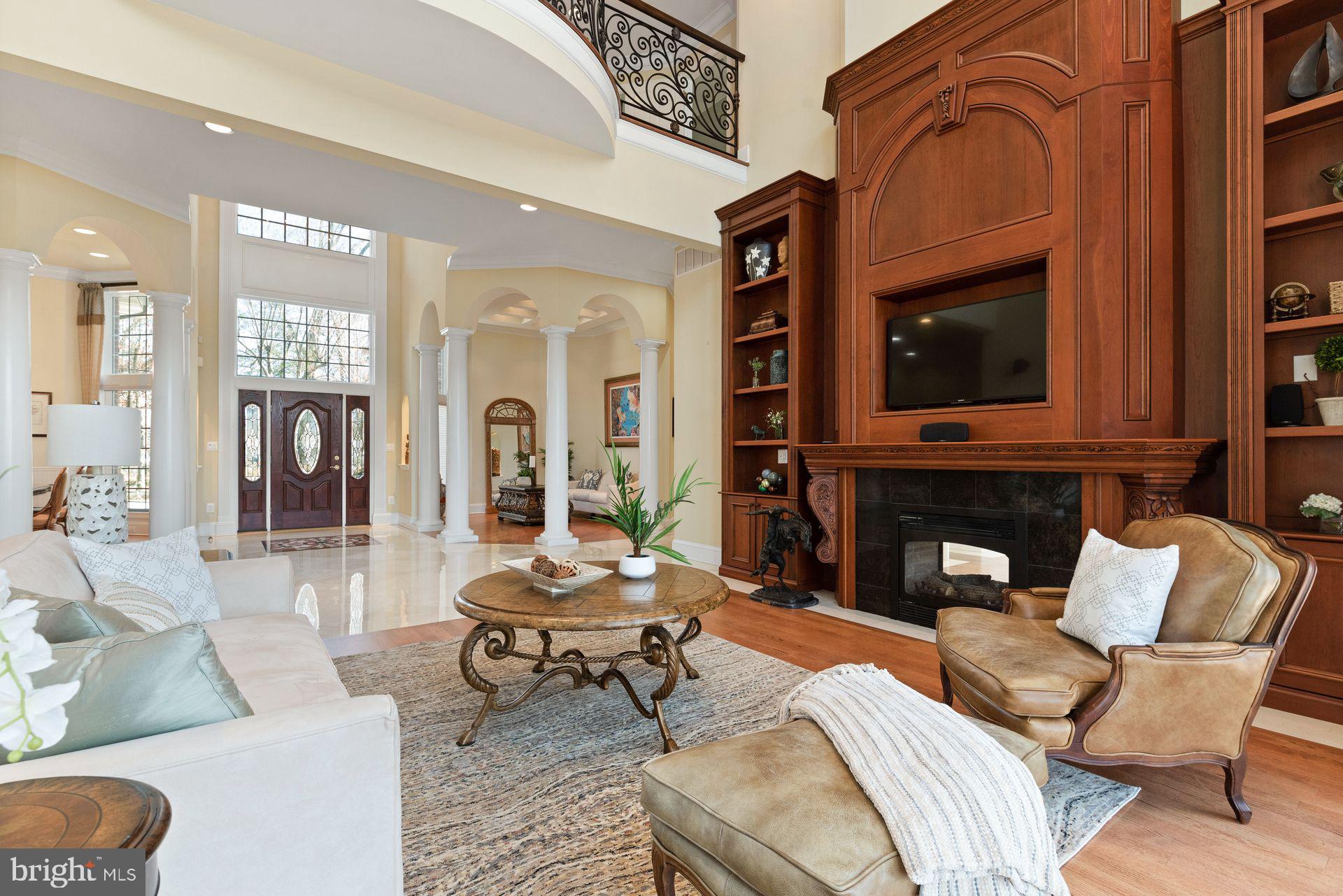4132 Cadle Creek Road Edgewater, MD 21037 - Photo 12 of 85 a living room with furniture a fireplace and a flat screen tv