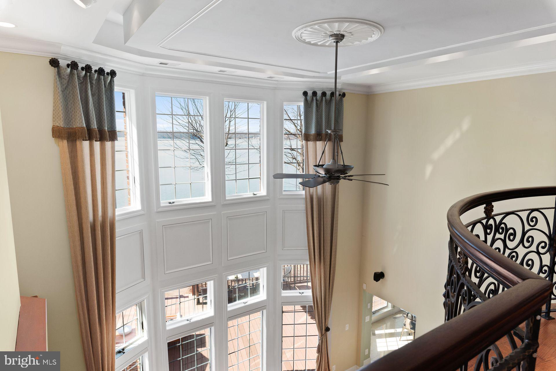 4132 Cadle Creek Road Edgewater, MD 21037 - Photo 18 of 85 a view of a hallway with windows and chandelier