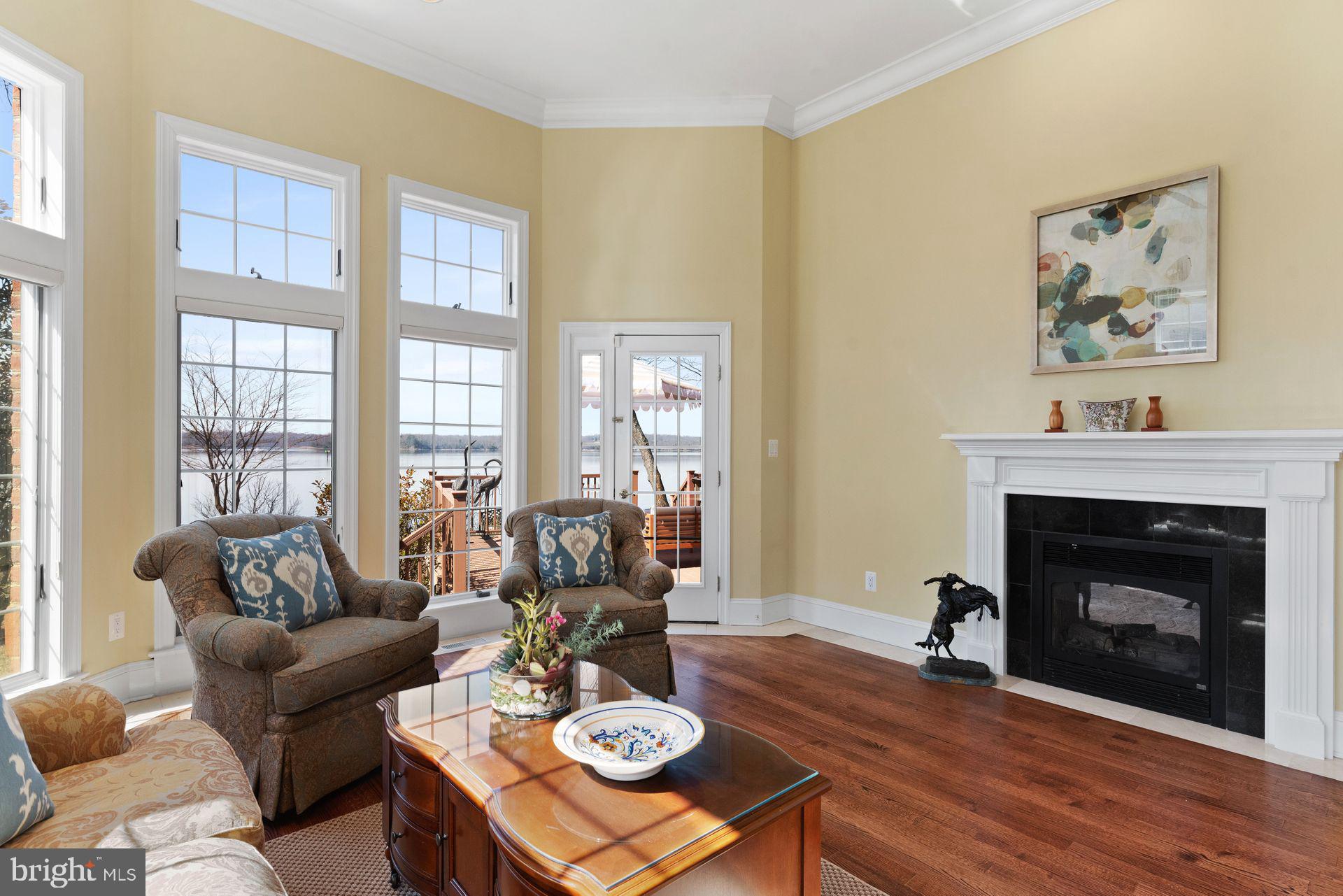 4132 Cadle Creek Road Edgewater, MD 21037 - Photo 20 of 85 a living room with furniture a fireplace and a large window