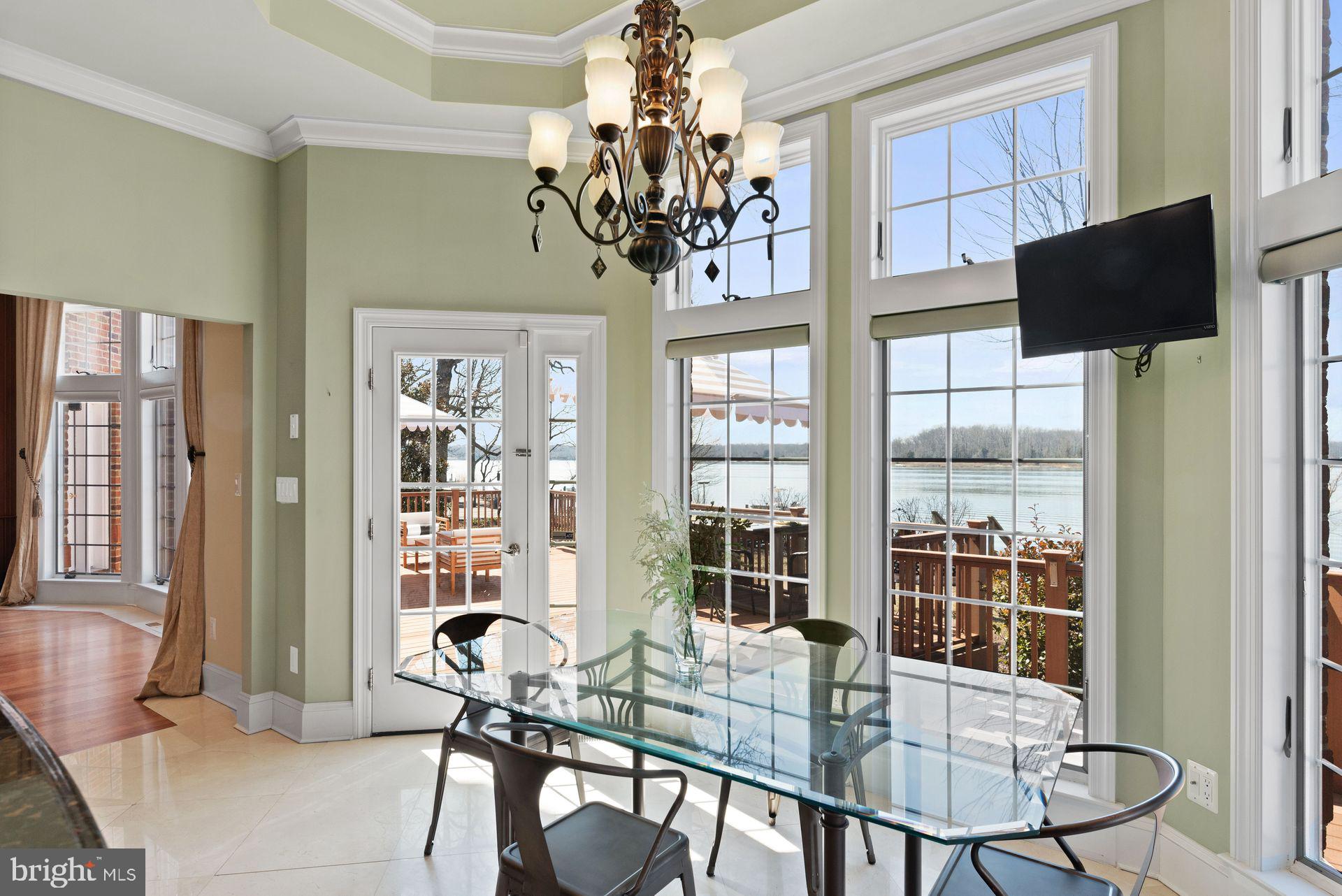 4132 Cadle Creek Road Edgewater, MD 21037 - Photo 23 of 85 a view of a dining room with furniture and a chandelier