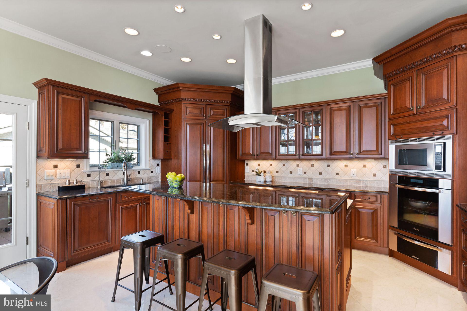 4132 Cadle Creek Road Edgewater, MD 21037 - Photo 25 of 85 a kitchen with stainless steel appliances kitchen island granite countertop a stove a sink and a refrigerator
