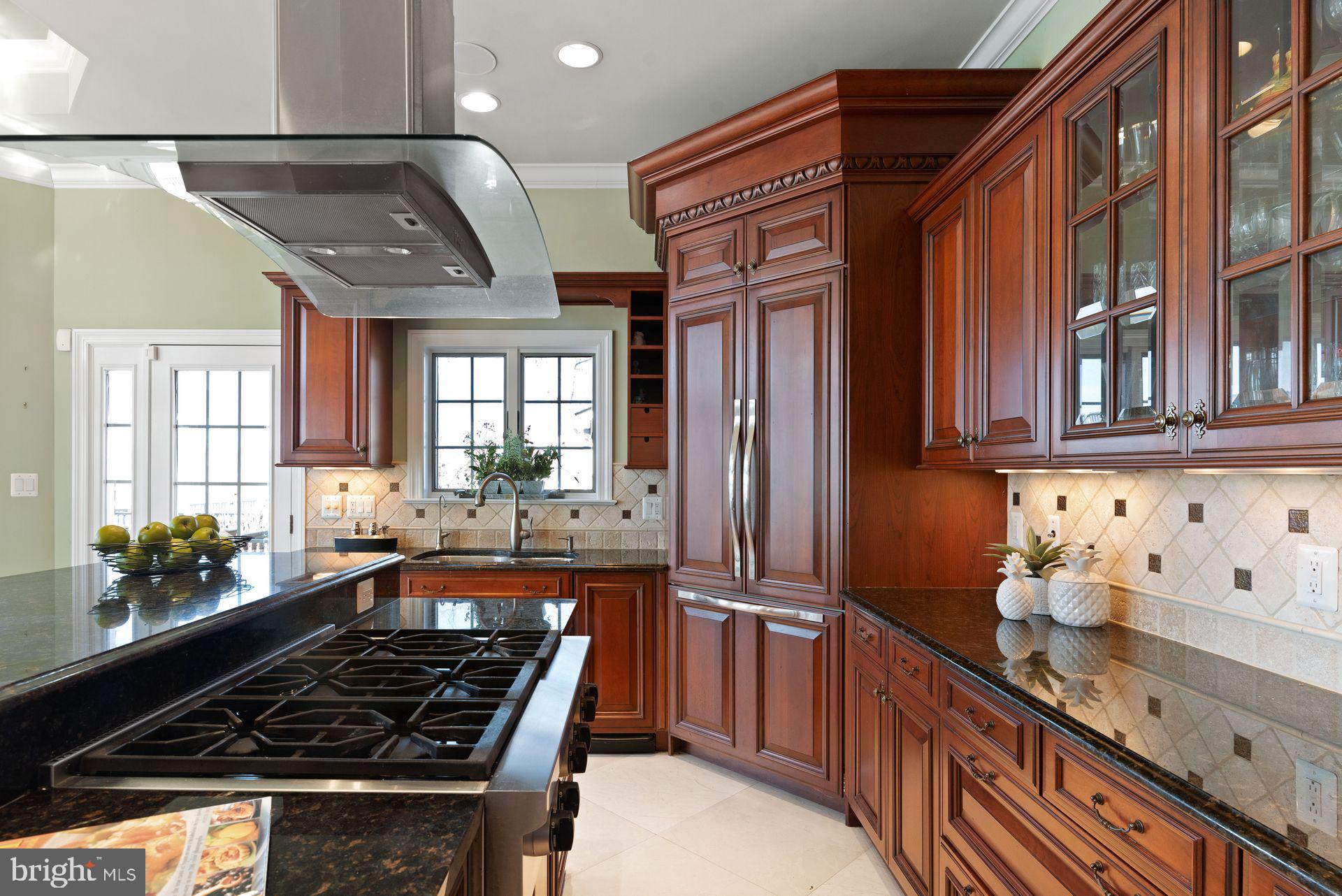 4132 Cadle Creek Road Edgewater, MD 21037 - Photo 26 of 85 a kitchen with stainless steel appliances a sink stove and cabinets