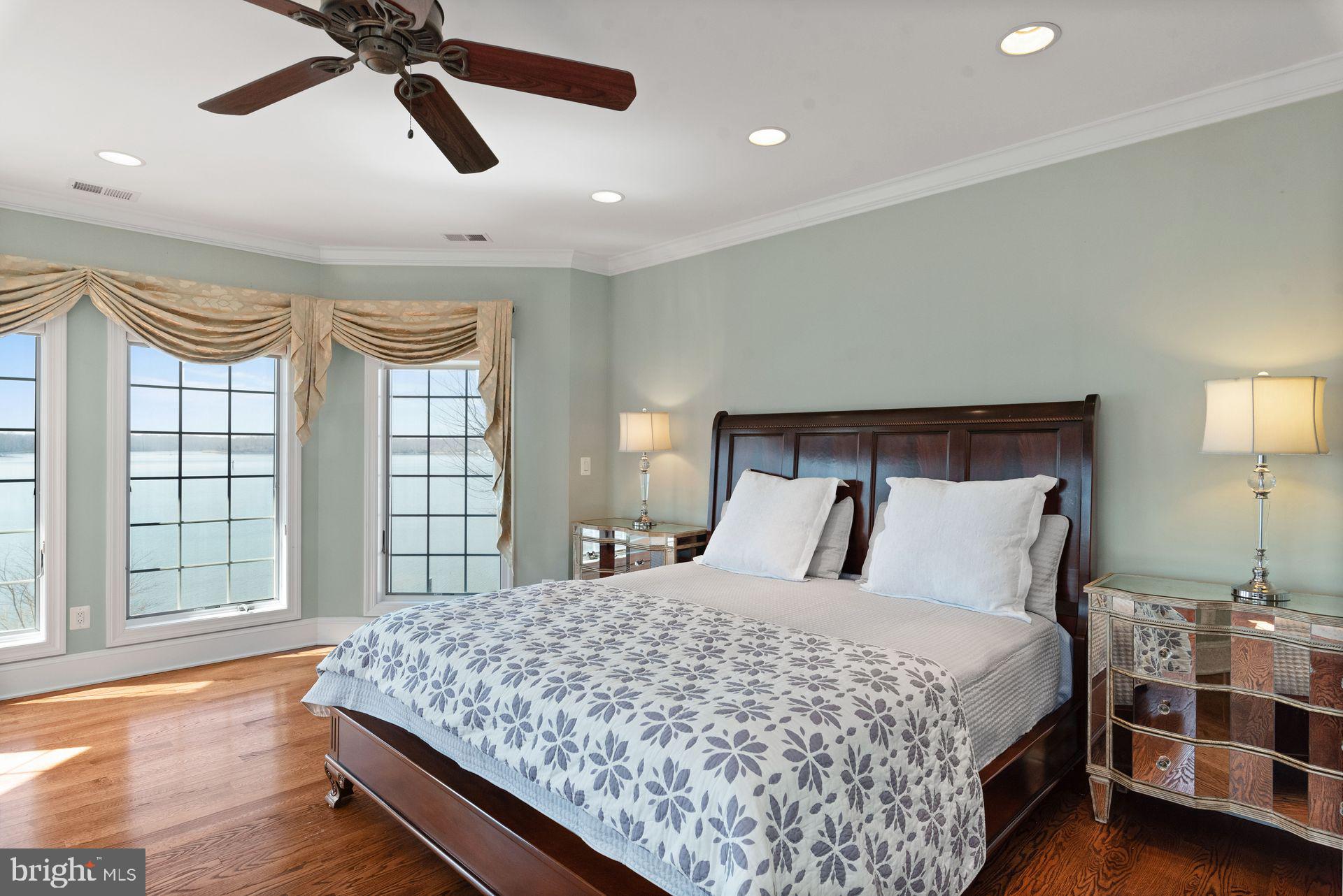 4132 Cadle Creek Road Edgewater, MD 21037 - Photo 43 of 85 a bedroom with a large bed and a large window