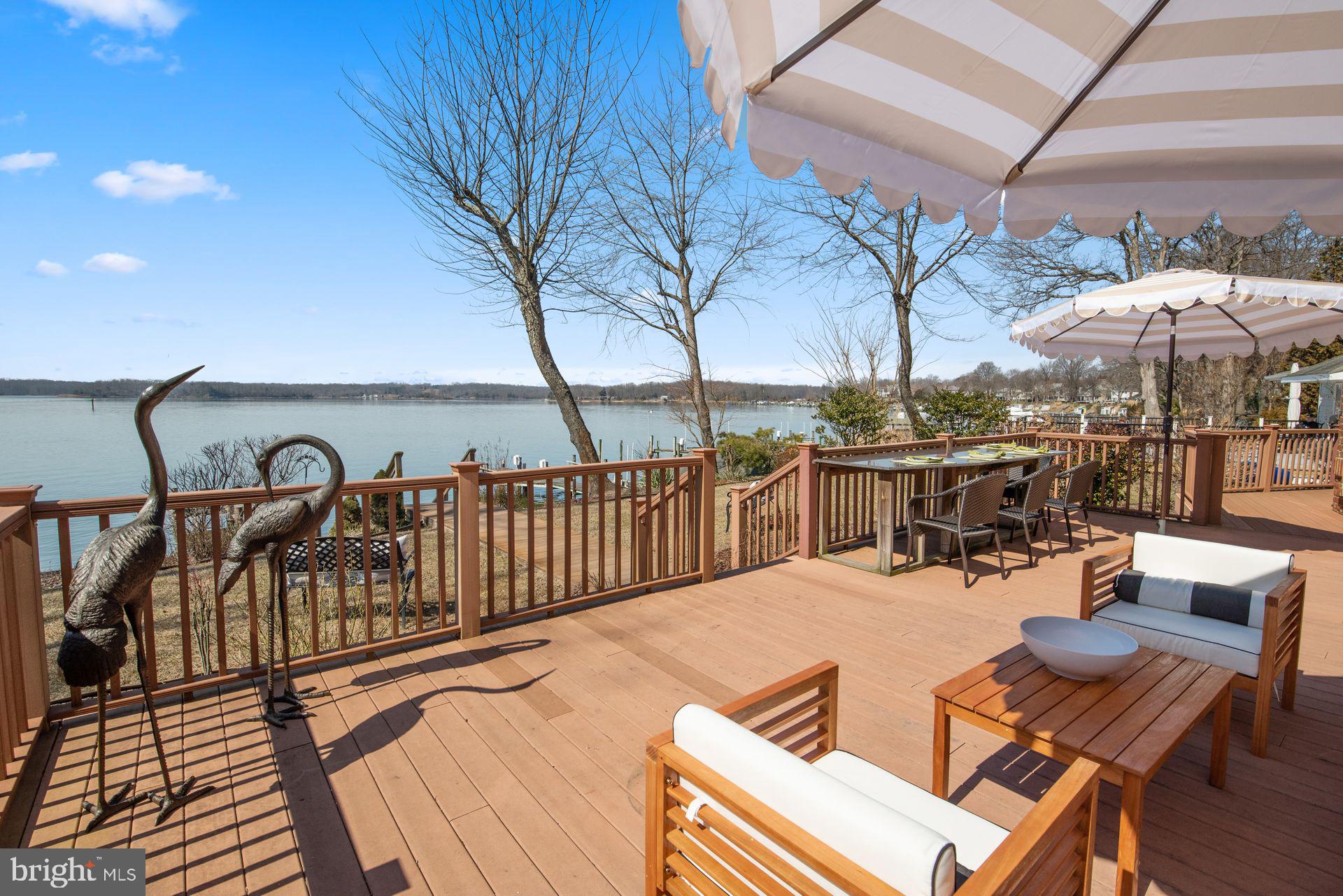 4132 Cadle Creek Road Edgewater, MD 21037 - Photo 68 of 85 a view of a patio with a table chairs and wooden floor