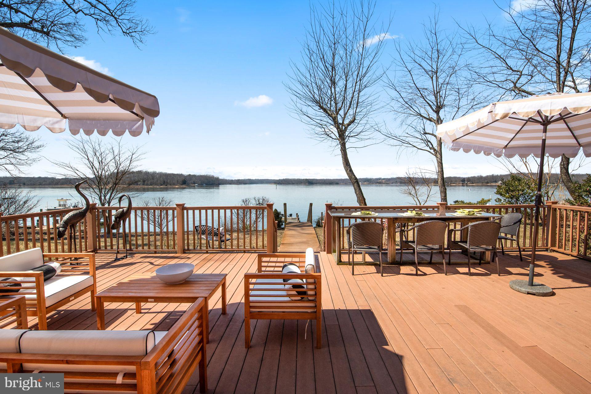 4132 Cadle Creek Road Edgewater, MD 21037 - Photo 81 of 85 a view of a balcony with chairs and wooden floor