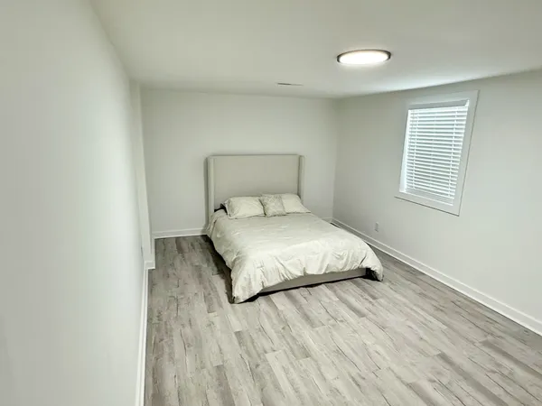 a view of an empty room and wooden floor