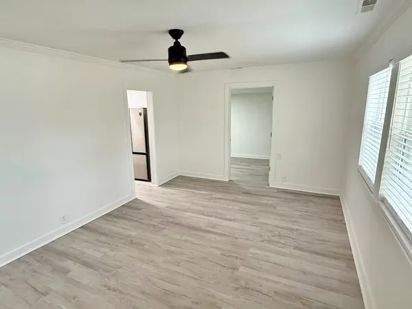 wooden floor in an empty room with a window